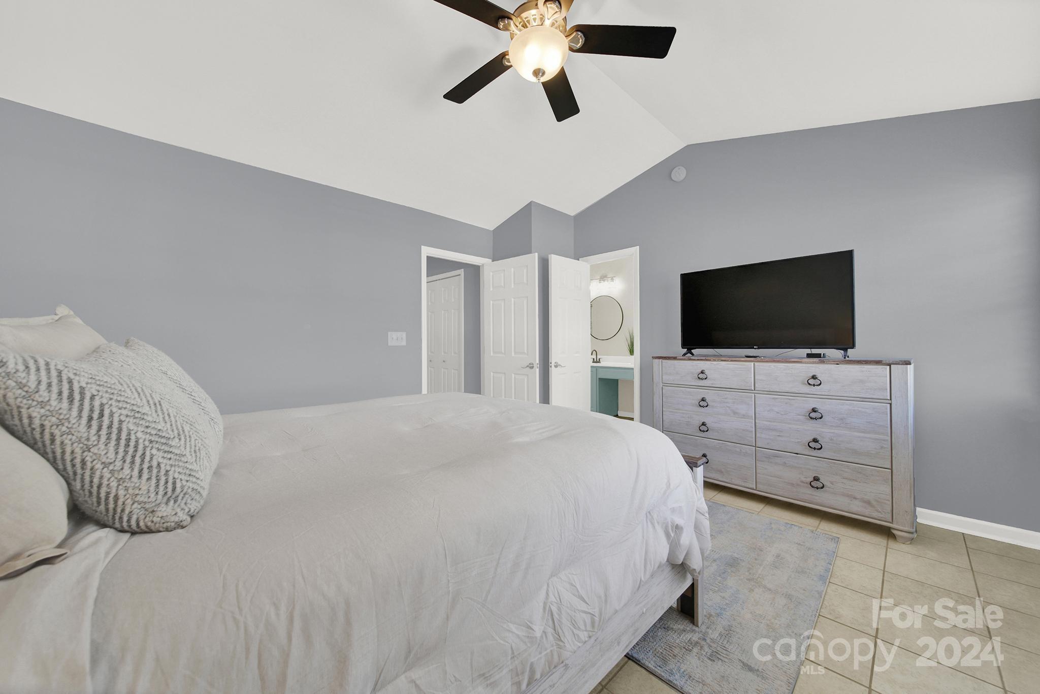 8134 Rudolph Road Charlotte, NC 28216 - Photo 19 of 27 a bedroom with a bed tv and flat screen tv