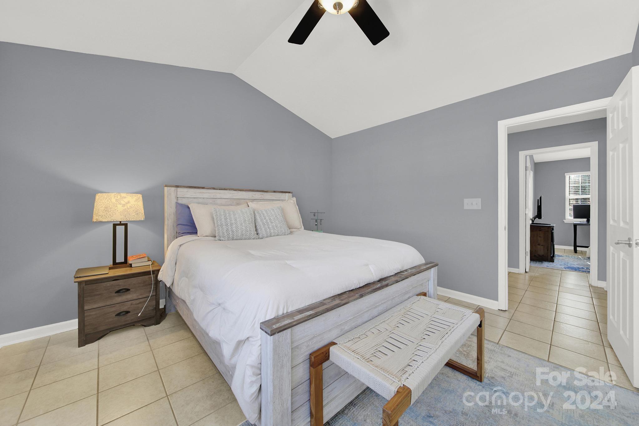 8134 Rudolph Road Charlotte, NC 28216 - Photo 20 of 27 a bedroom with a bed and a lamp