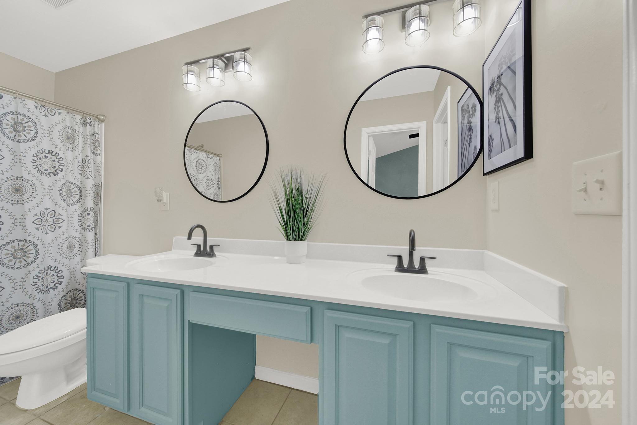 8134 Rudolph Road Charlotte, NC 28216 - Photo 21 of 27 a bathroom with a sink and a mirror