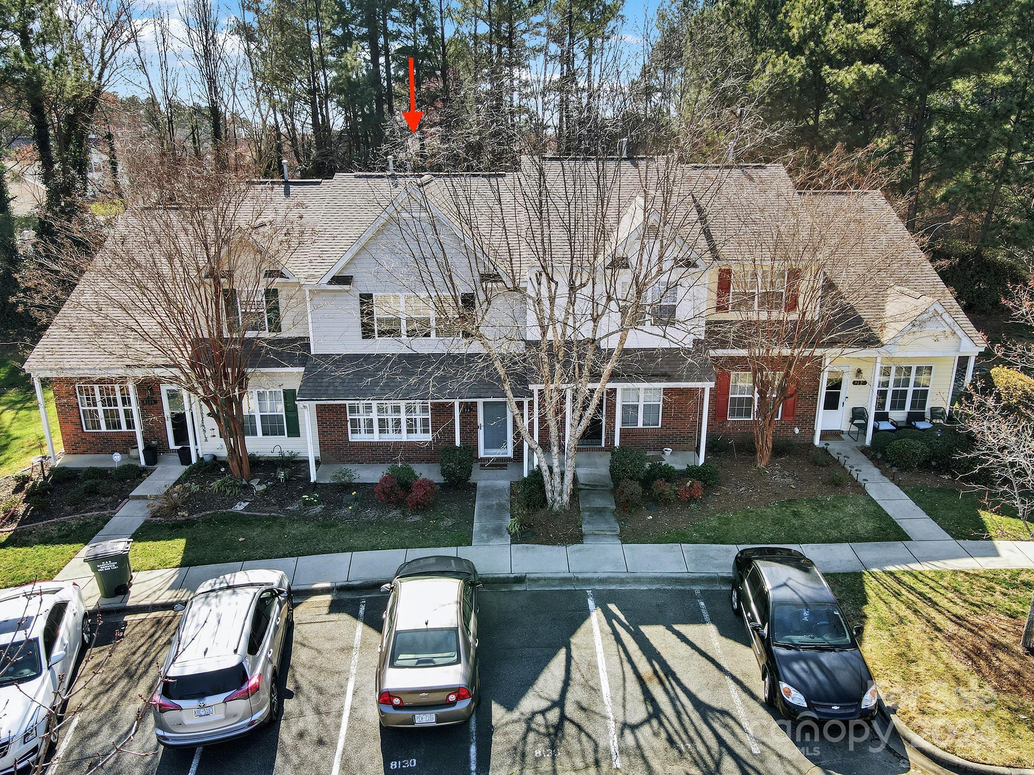 8134 Rudolph Road Charlotte, NC 28216 - Photo 3 of 27 a view of a big house with swimming pool lawn chairs and a yard