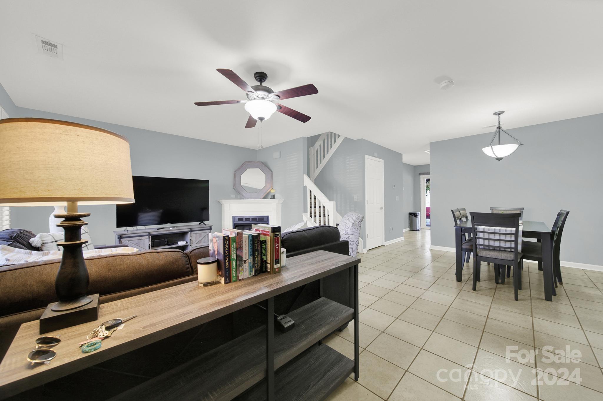 8134 Rudolph Road Charlotte, NC 28216 - Photo 10 of 27 a living room with furniture a flat screen tv and kitchen view