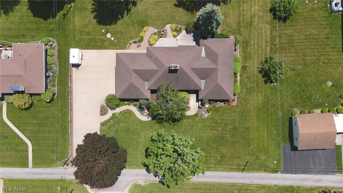 3985 Wiers Road Willard, OH 44890 - Photo 4 of 50 Expansive property featuring a large residence with a multi-gabled roof, extensive green lawn, mature trees, a detached auxiliary building, and a paved driveway