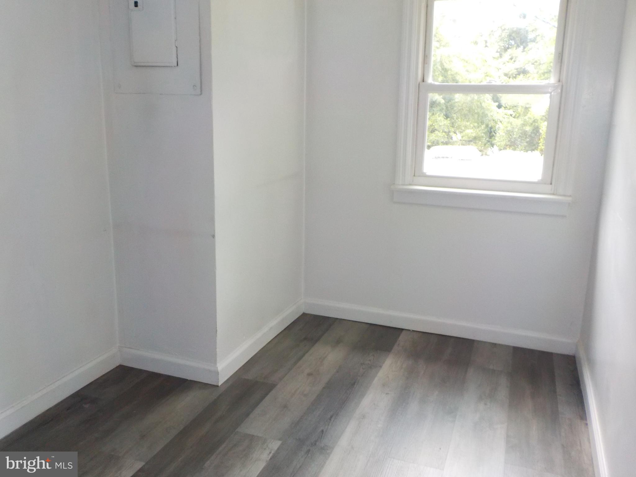 16 Oak Street, Unit R Salem, NJ 08079 - Photo 12 of 20 an empty room with wooden floor and windows