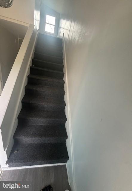 16 Oak Street, Unit R Salem, NJ 08079 - Photo 19 of 20 a view of staircase with lots of frames on wall