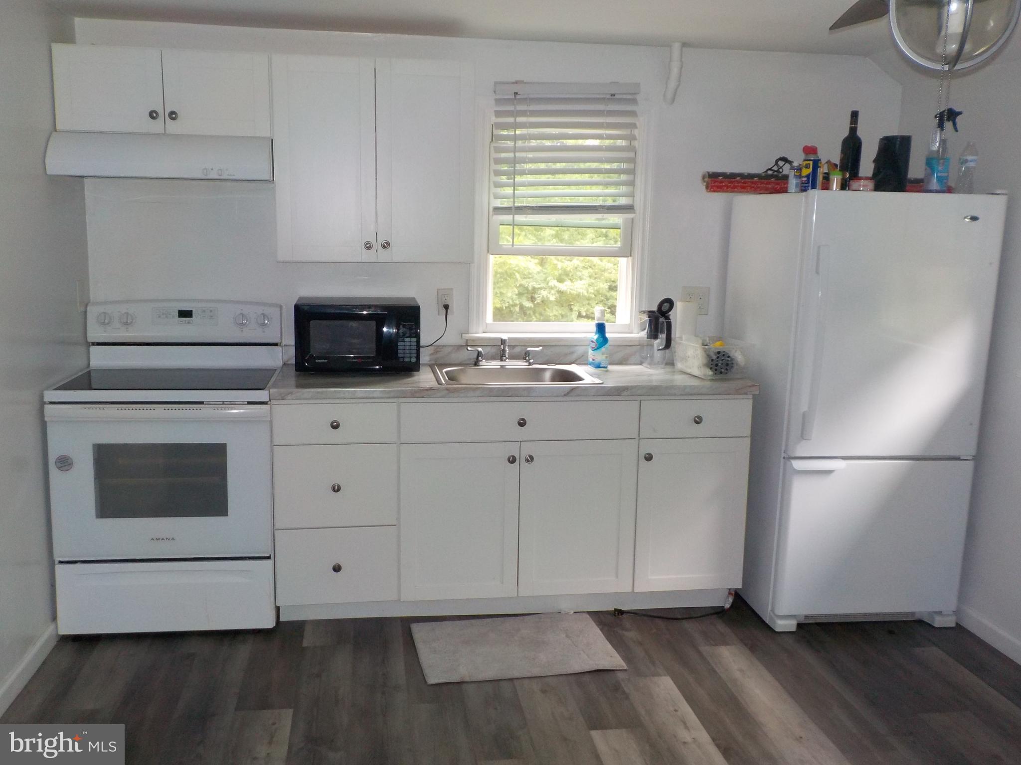 16 Oak Street, Unit R Salem, NJ 08079 - Photo 2 of 20 a kitchen with granite countertop white cabinets and white appliances