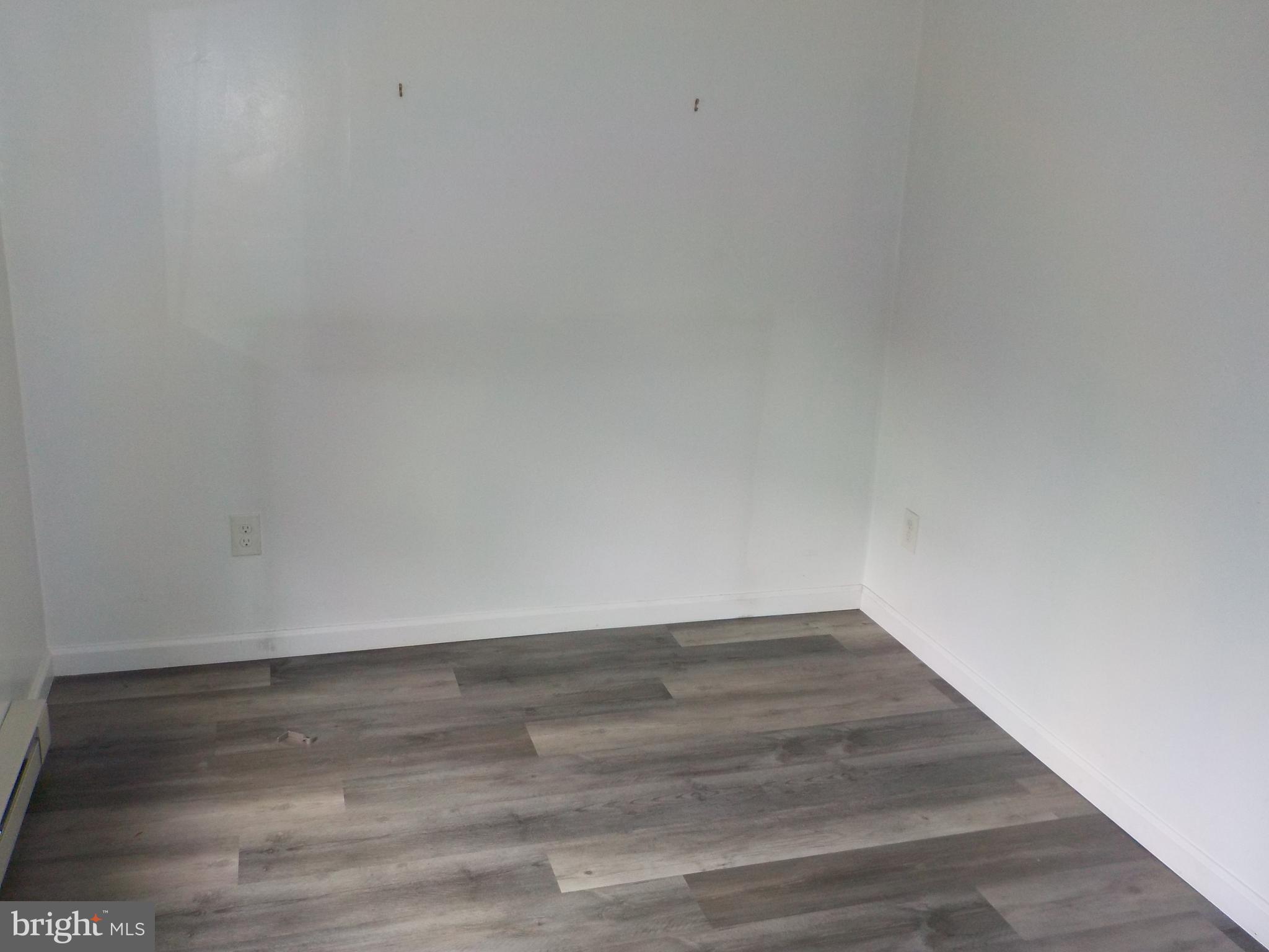 16 Oak Street, Unit R Salem, NJ 08079 - Photo 6 of 20 a view of an empty room with wooden floor