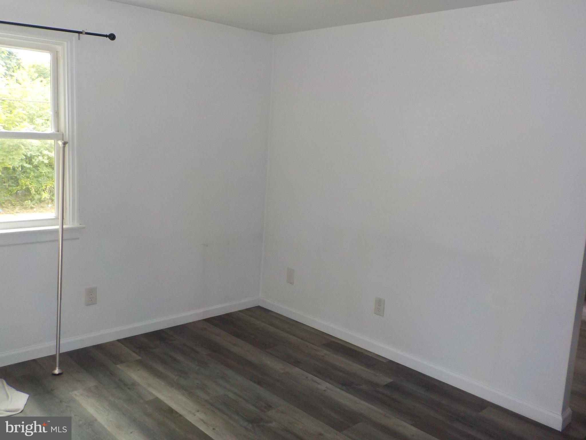 16 Oak Street, Unit R Salem, NJ 08079 - Photo 7 of 20 an empty room with wooden floor and windows