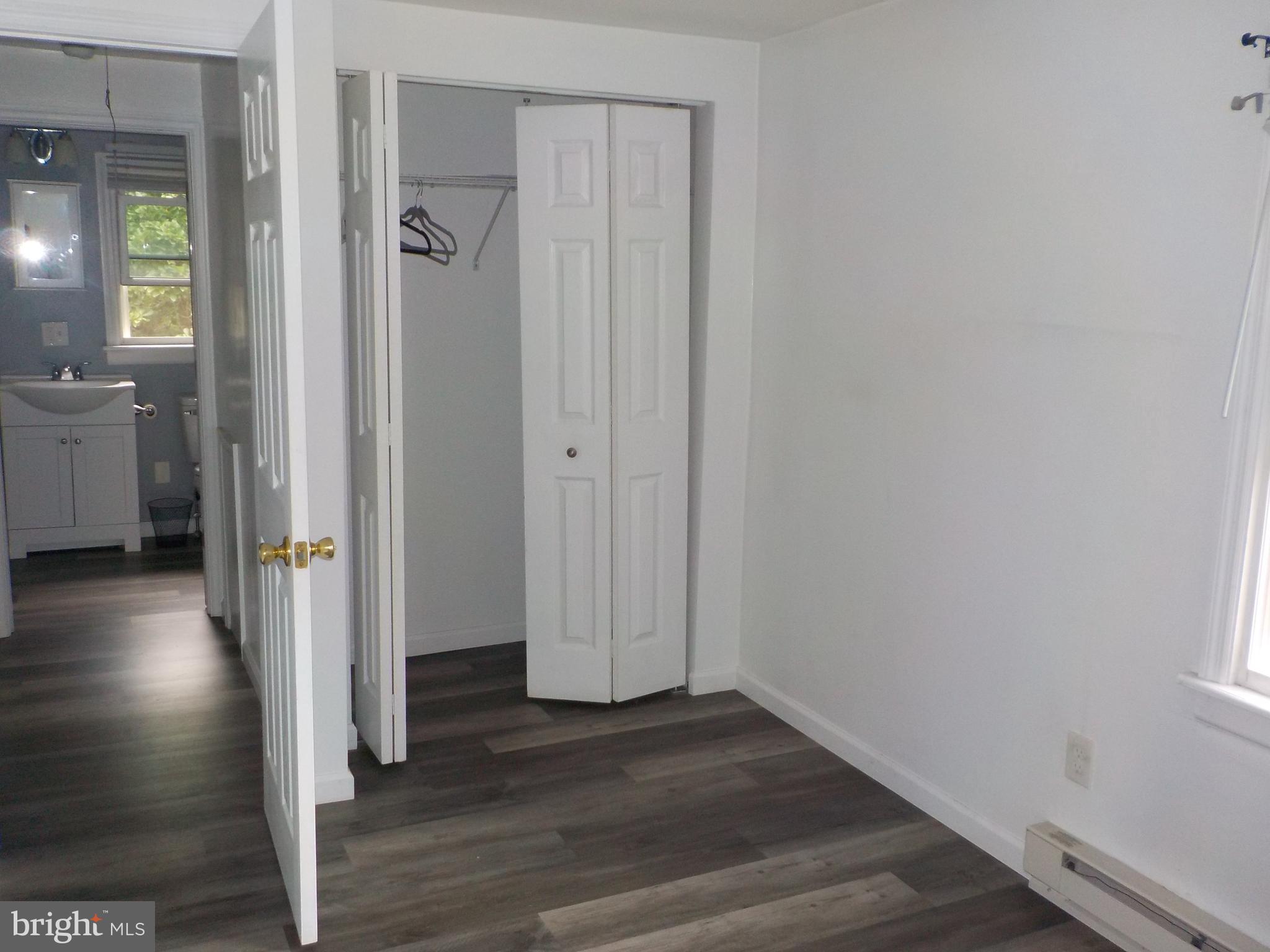 16 Oak Street, Unit R Salem, NJ 08079 - Photo 9 of 20 a view of a hallway with wooden floor and a bathroom