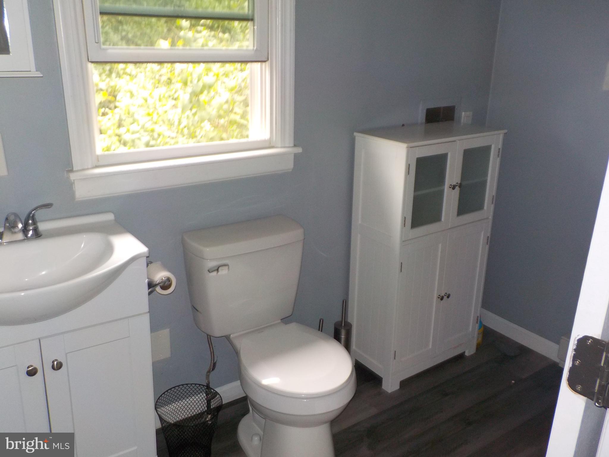 16 Oak Street, Unit R Salem, NJ 08079 - Photo 10 of 20 a white toilet sitting next to a bathroom sink