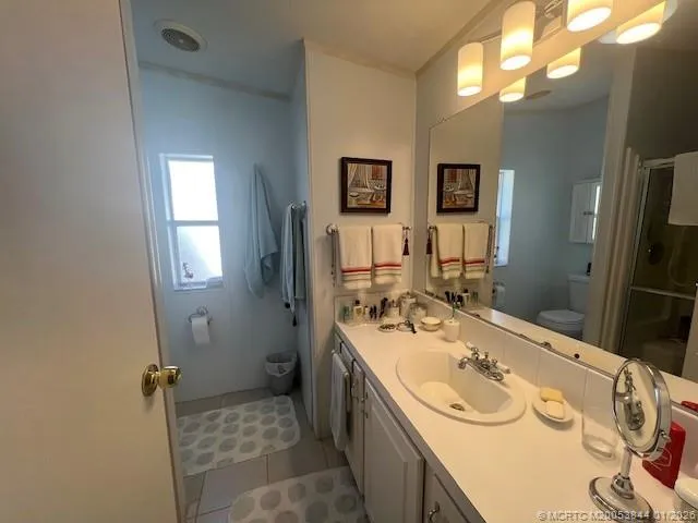 a white toilet sitting next to a bathroom sink