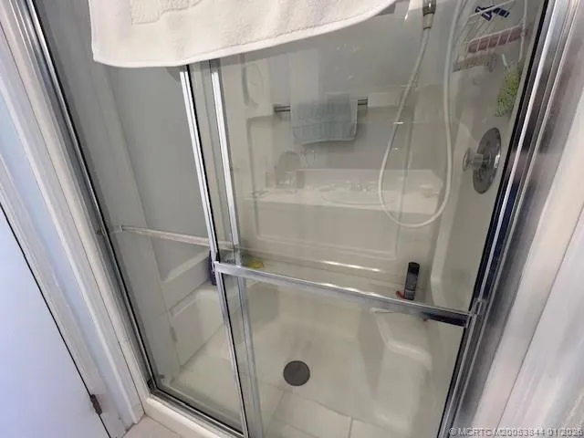 a bathroom with a sink a chandelier and a mirror