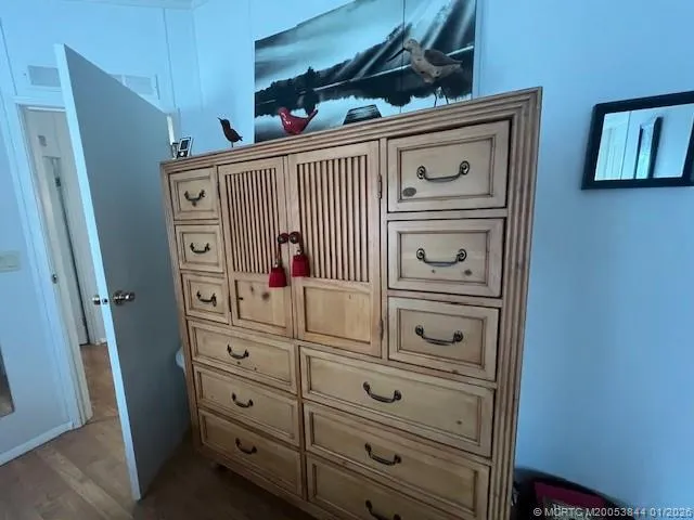 a kitchen with a refrigerator and a dresser