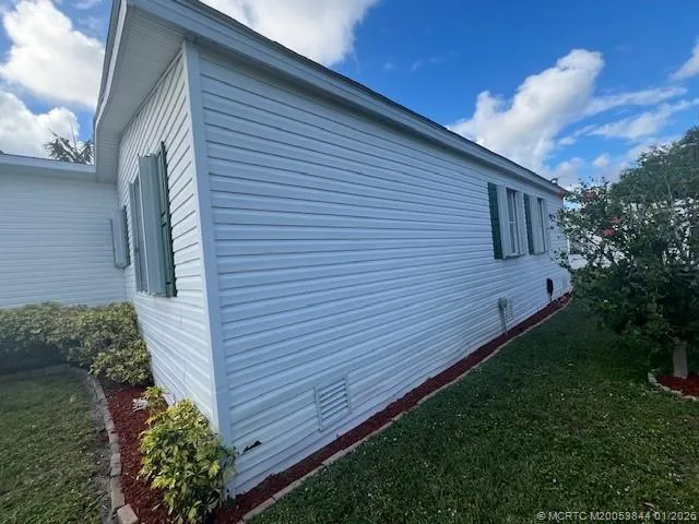 a view of a backyard with plants and a patio