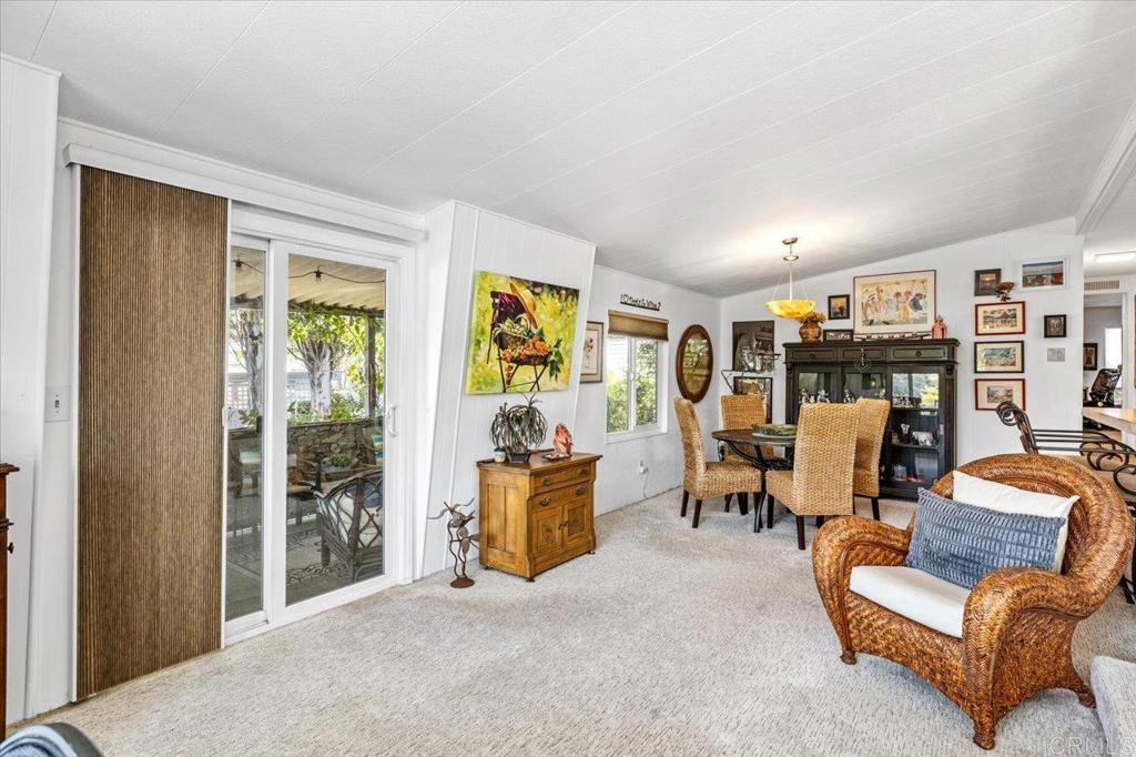 18218 Paradise Mountain Road, Unit 116 Valley Center, CA 92082 - Photo 11 of 35 a living room with furniture large window and flat screen tv