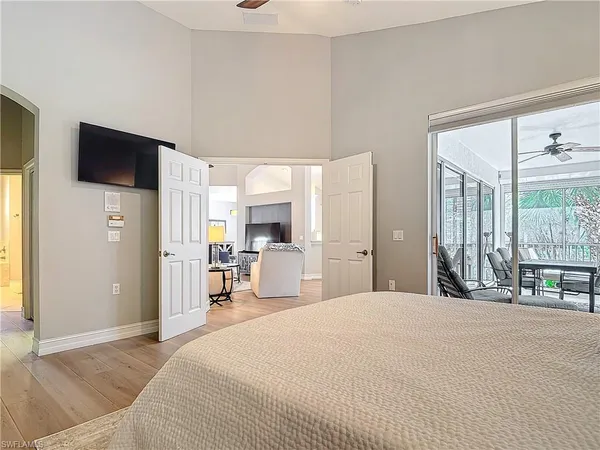 a bedroom with a bed and a flat screen tv