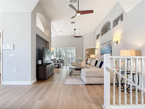 a living room with lots of furniture and a large window