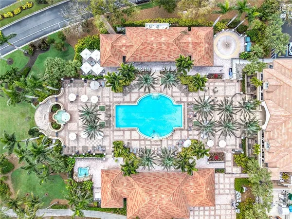an aerial view of residential houses with outdoor space and trees