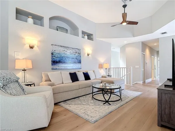 a living room with furniture and a lamp