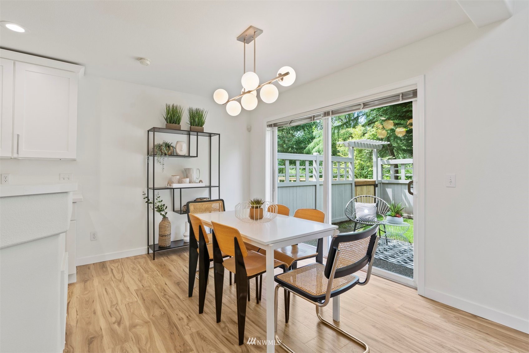 507 Elma Place Northeast Renton, WA 98059 - Photo 16 of 36 a dining room with wooden floor a chandelier a wooden table and chairs