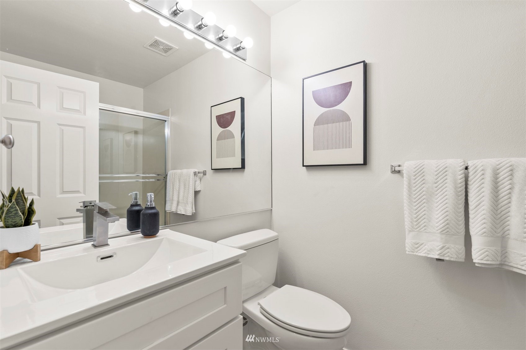 507 Elma Place Northeast Renton, WA 98059 - Photo 32 of 36 a bathroom with a sink mirror vanity and toilet
