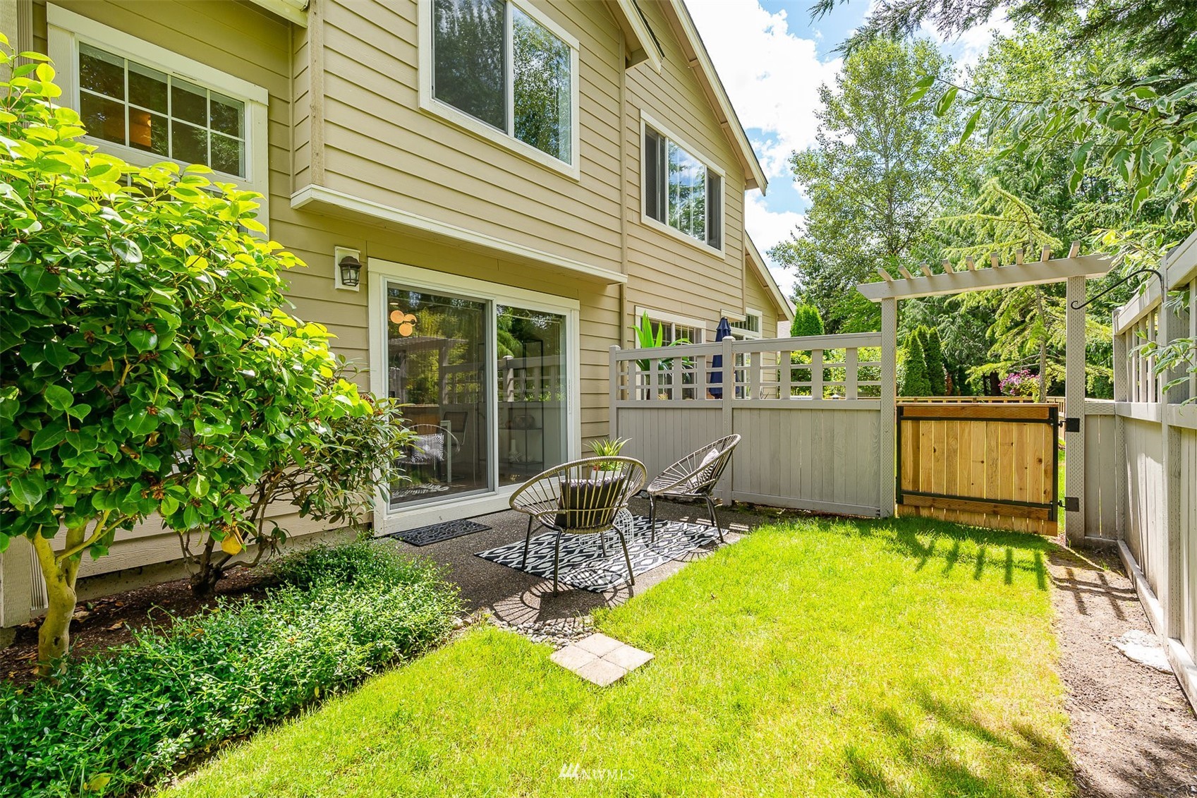 507 Elma Place Northeast Renton, WA 98059 - Photo 35 of 36 a view of a backyard with table and chairs and potted plants