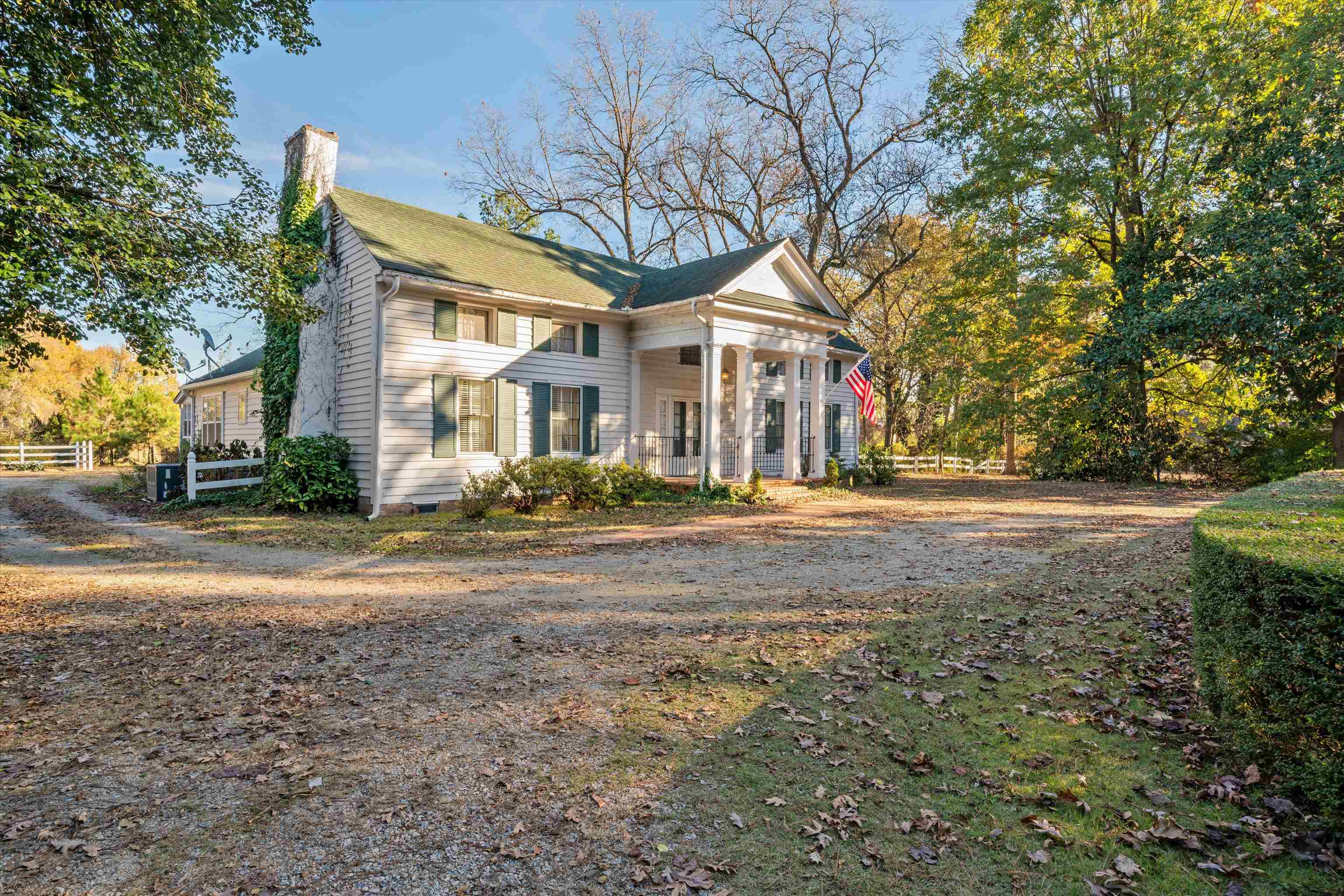 a view of a white house with a street