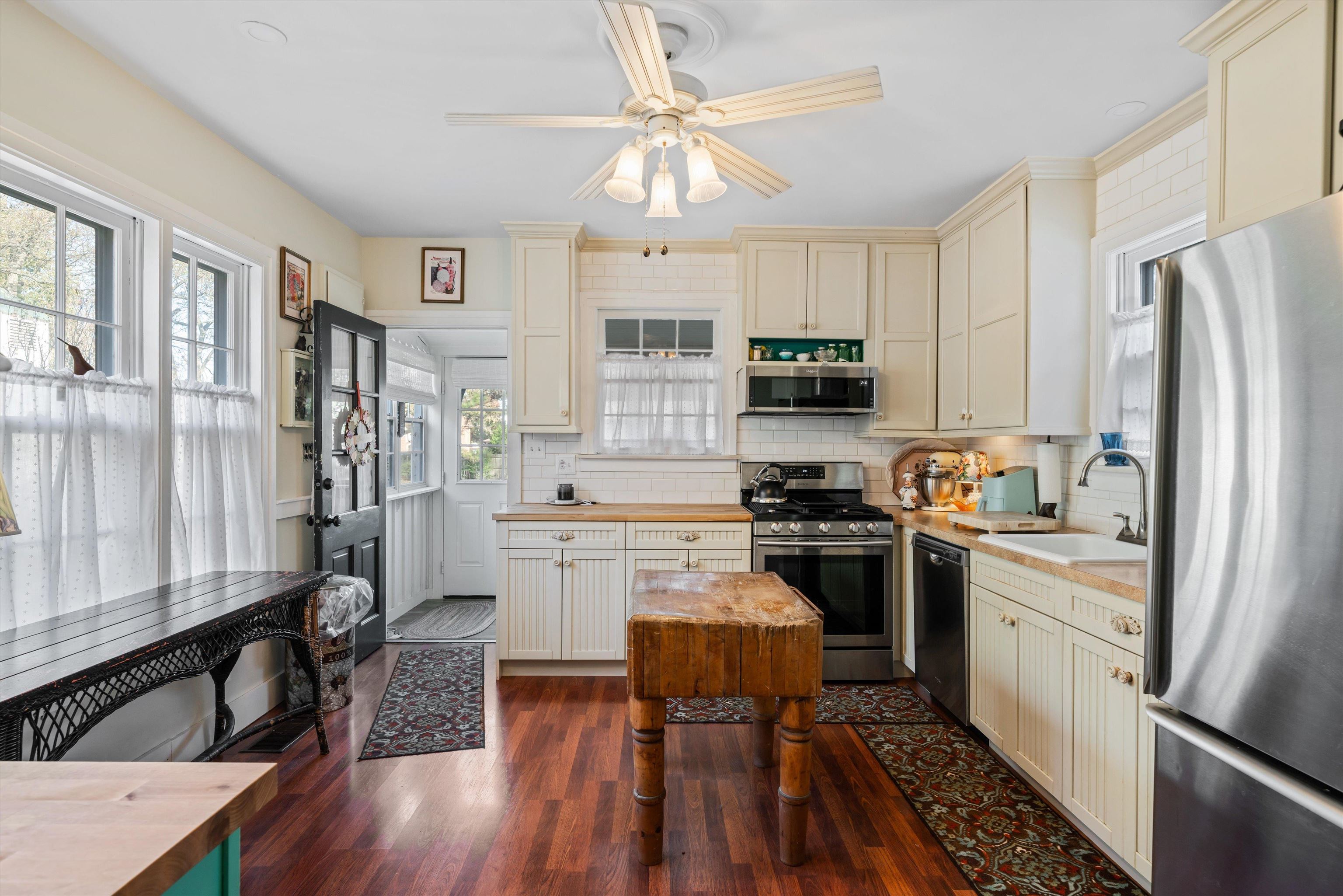 4375 Old Forest Road Memphis, TN 38125 - Photo 9 of 21 a kitchen with a refrigerator a stove a sink dishwasher and a dining table with wooden floor