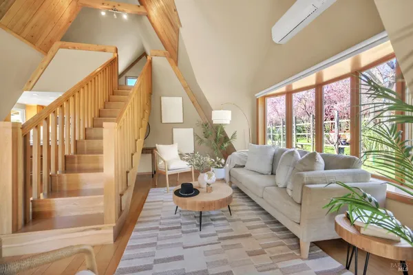 a living room with fireplace furniture and a large window