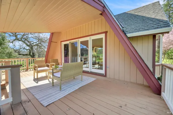 a balcony with wooden floor and furniture