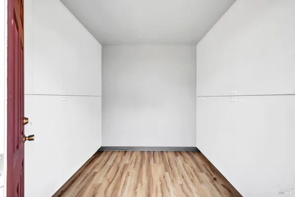 a view of hallway with wooden floor