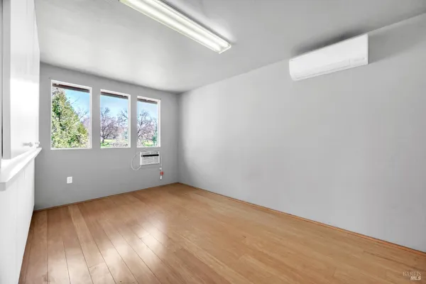 a view of an empty room and wooden floor