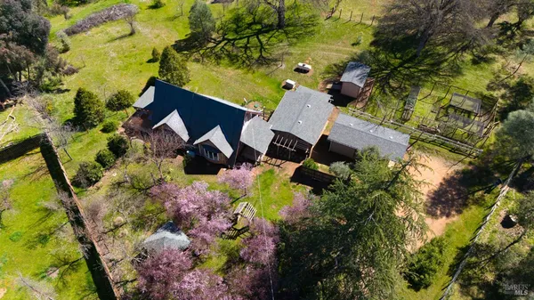 a view of a house with a yard fire pit and outdoor seating
