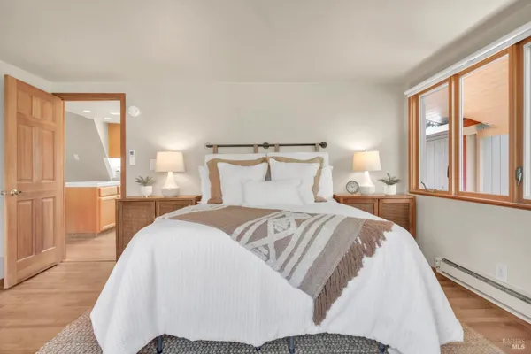 a bedroom with a bed and glass window