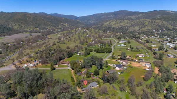 an aerial view of residential houses with yard