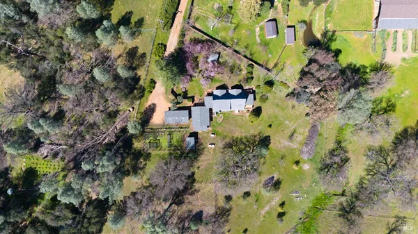 an aerial view of house with a yard