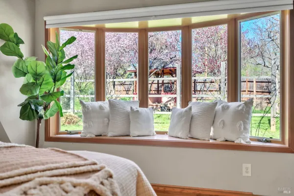 a bed sitting in a bedroom next to a window
