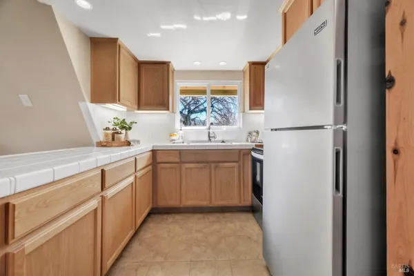 a kitchen with a sink and refrigerator