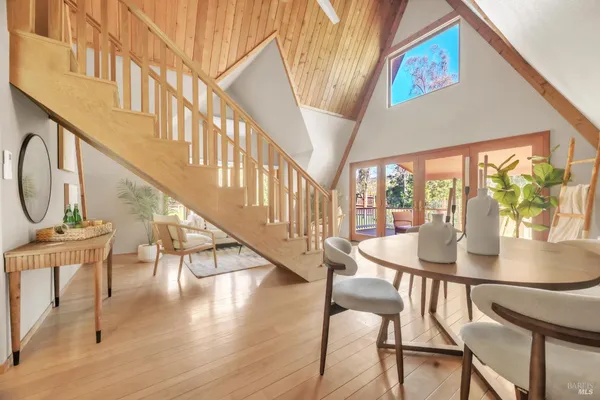a view of a dining room with furniture a chandelier and wooden floor