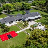 an aerial view of a house with pool outdoor seating and yard