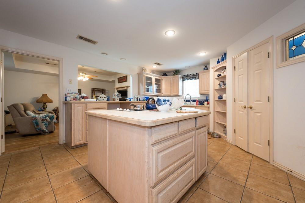 9554 David Fort Road Argyle, TX 76226 - Photo 10 of 35 a kitchen with stainless steel appliances kitchen island granite countertop a sink and cabinets