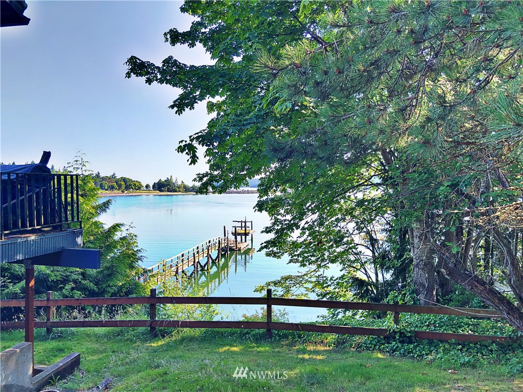 3123 West Sequim Bay Road Sequim, WA 98382 - Photo 5 of 6 a view of a lake with a big yard and potted plants