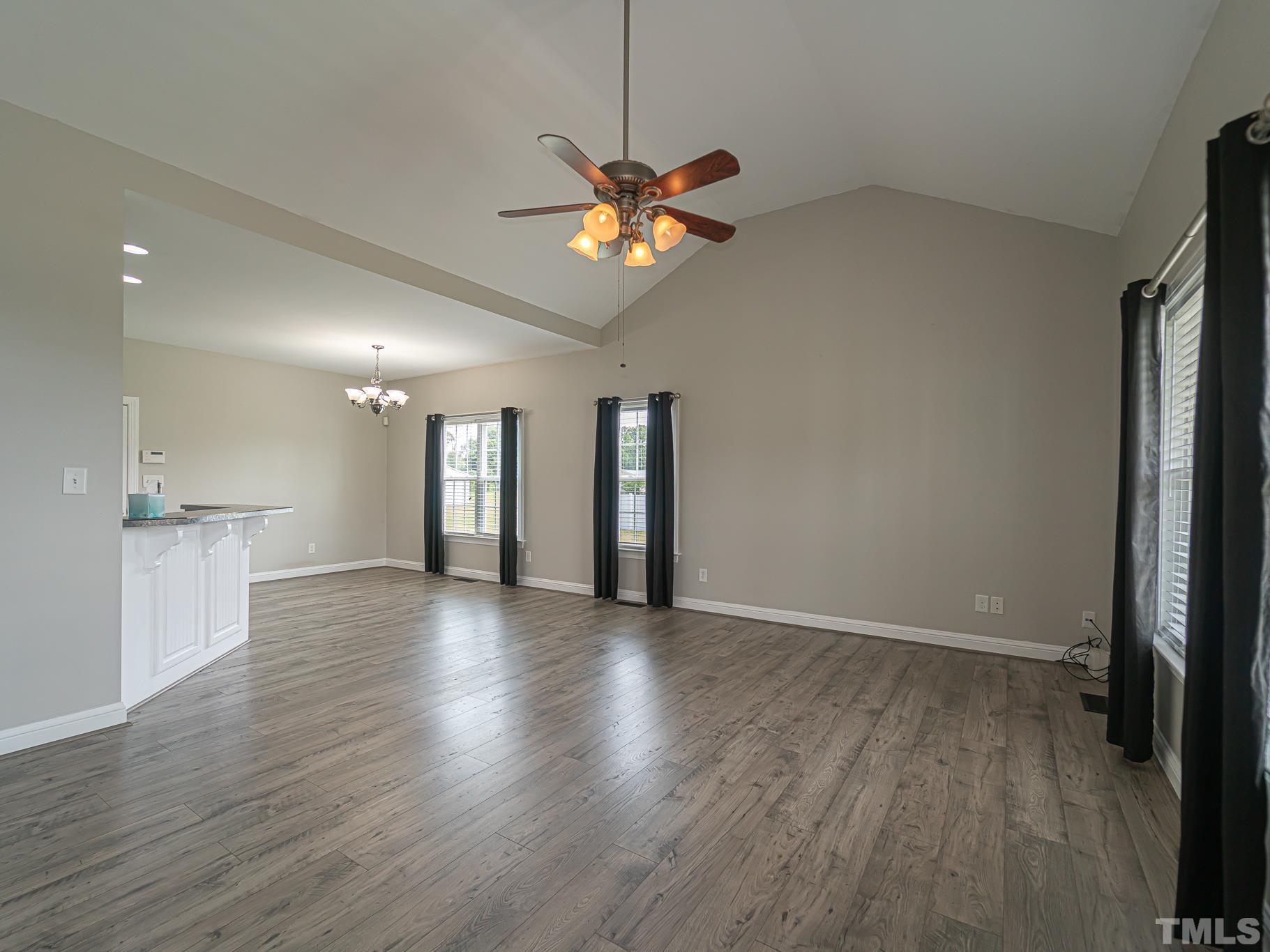 7730 La Finca Road Elm City, NC 27822 - Photo 14 of 29 a view of a livingroom with a hardwood floor and a ceiling fan