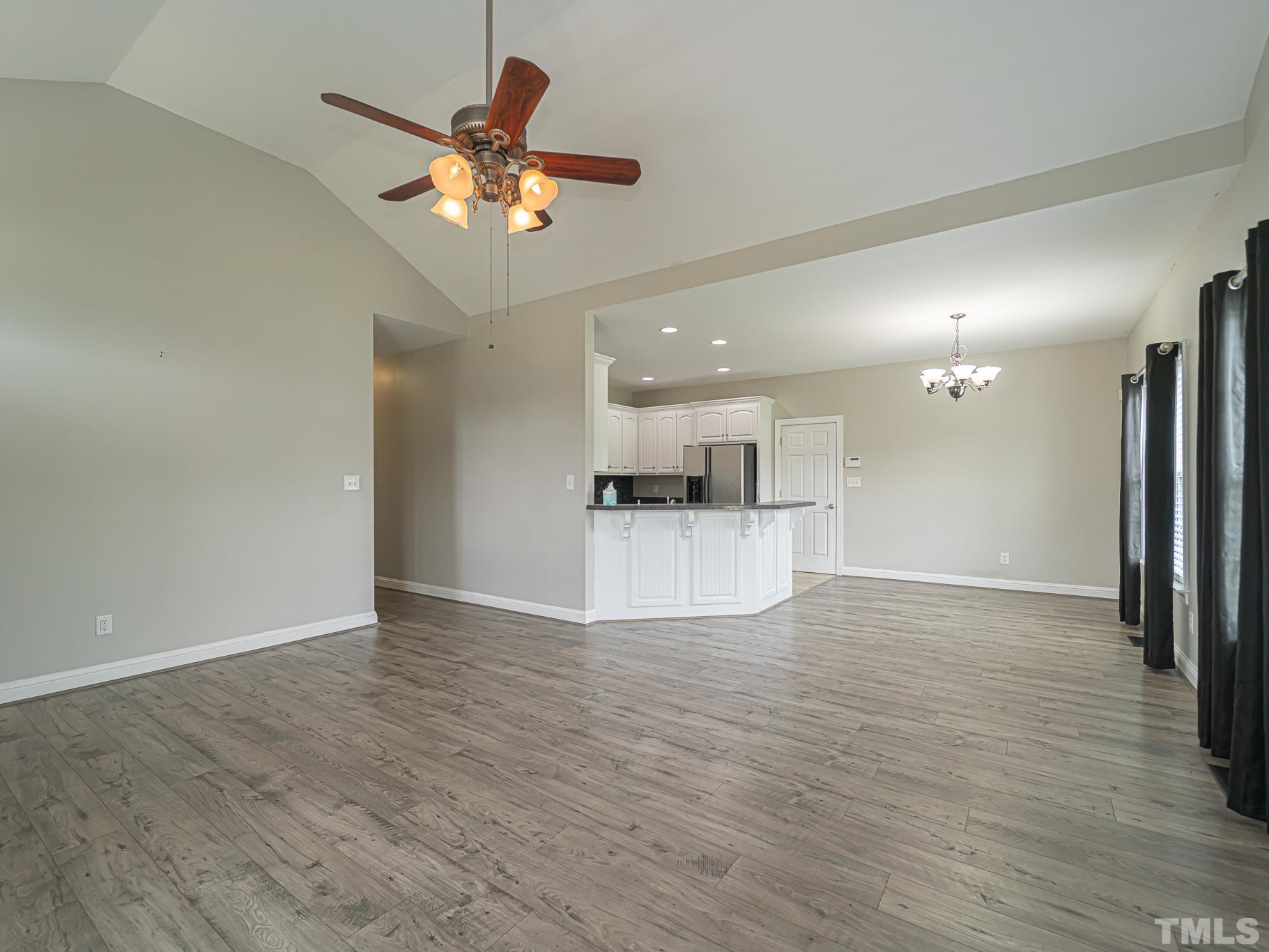 7730 La Finca Road Elm City, NC 27822 - Photo 15 of 29 a view of an empty room with wooden floor and a ceiling fan