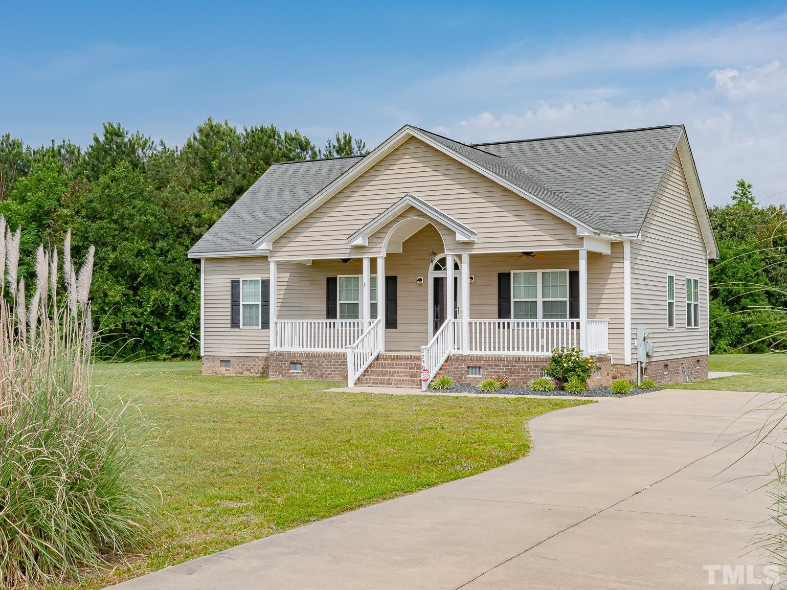 7730 La Finca Road Elm City, NC 27822 - Photo 2 of 29 a front view of a house with a yard and porch