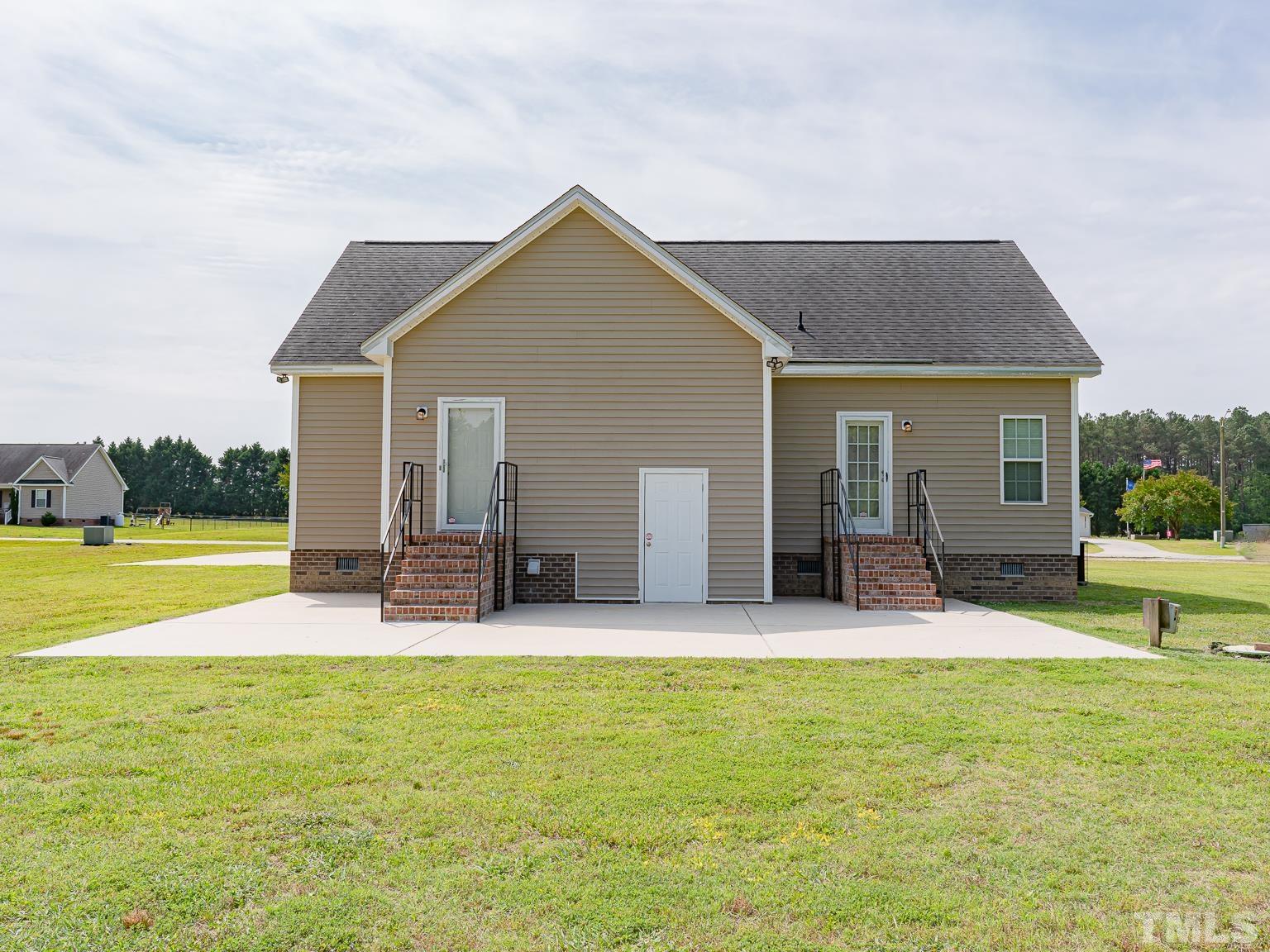 7730 La Finca Road Elm City, NC 27822 - Photo 26 of 29 a house view with swimming pool and yard