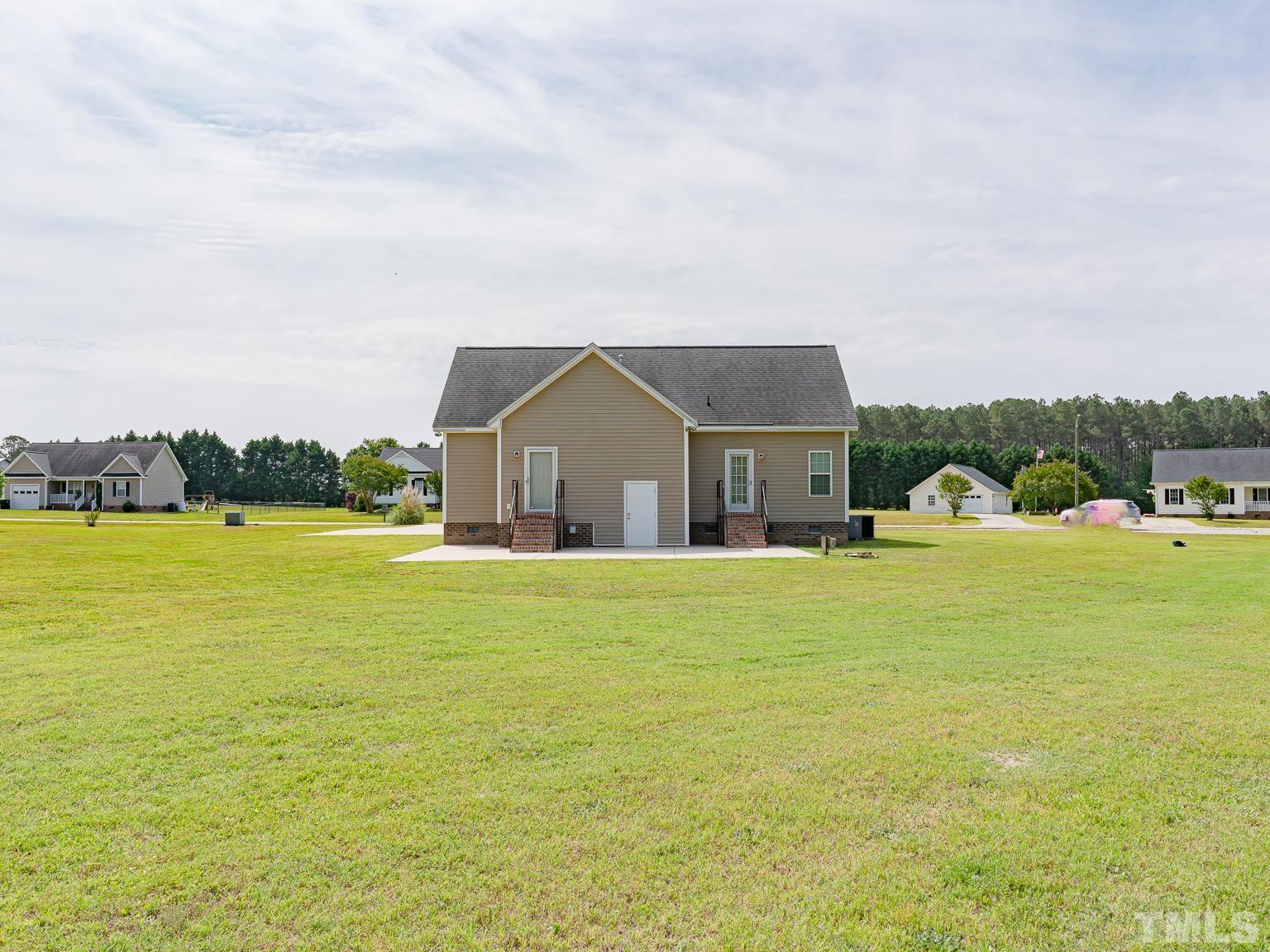 7730 La Finca Road Elm City, NC 27822 - Photo 27 of 29 a front view of house with yard and lake