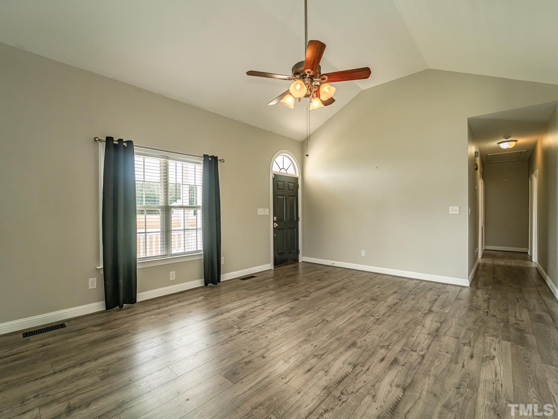 7730 La Finca Road Elm City, NC 27822 - Photo 5 of 29 a view of an empty room with wooden floor and a window