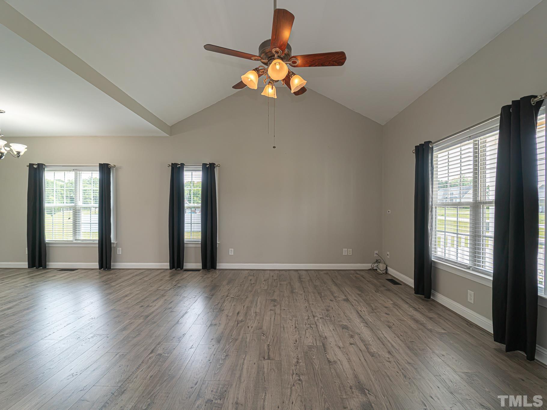 7730 La Finca Road Elm City, NC 27822 - Photo 6 of 29 a view of an empty room with wooden floor and a window