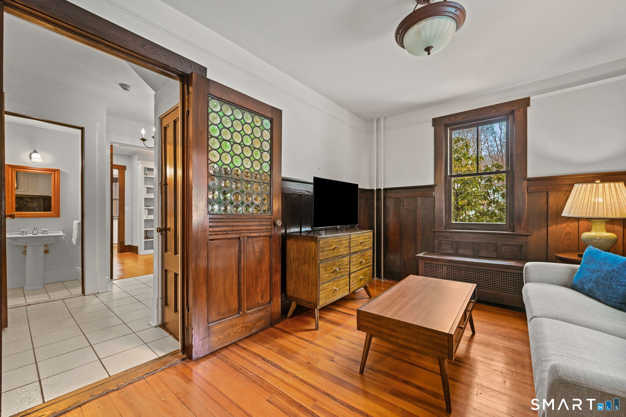 32 Catalpa Road Wilton, CT 06897 - Photo 13 of 36 a living room with furniture and a flat screen tv