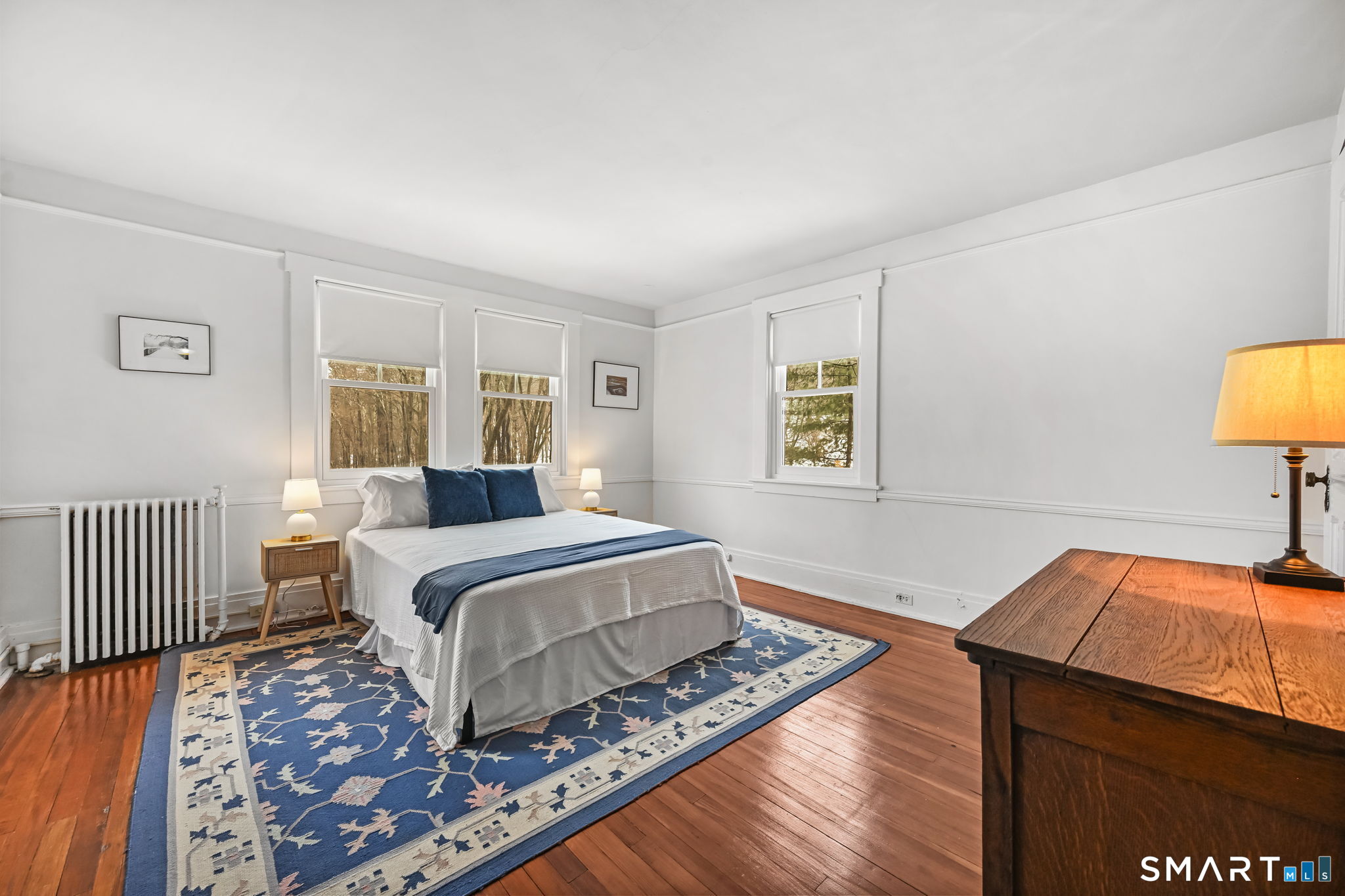 32 Catalpa Road Wilton, CT 06897 - Photo 17 of 36 a bedroom with a bed and a lamp on table